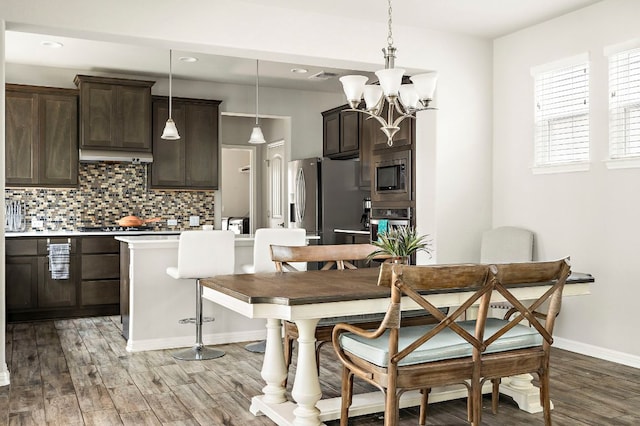 dining area with visible vents, baseboards, recessed lighting, light wood finished floors, and a notable chandelier