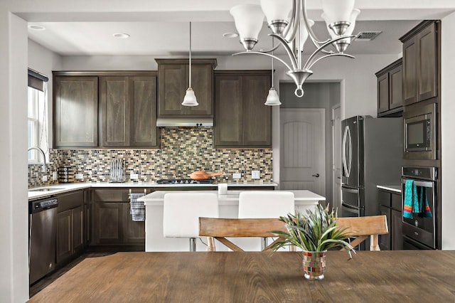 kitchen with visible vents, stainless steel appliances, an inviting chandelier, and dark brown cabinetry