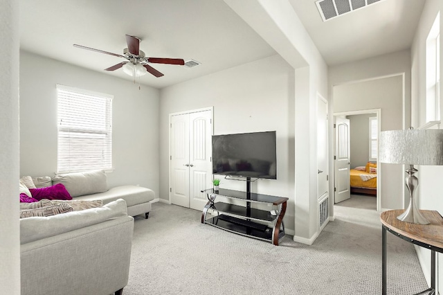 living room with visible vents, a ceiling fan, carpet flooring, and baseboards