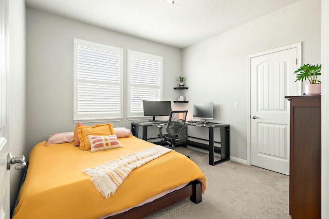 carpeted bedroom featuring baseboards