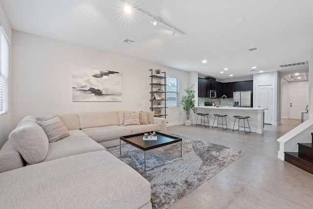 6224 Aviara Dr Unit E14, Austin, TX 78735 - living area with finished concrete flooring, recessed lighting, track lighting, baseboards, and stairway