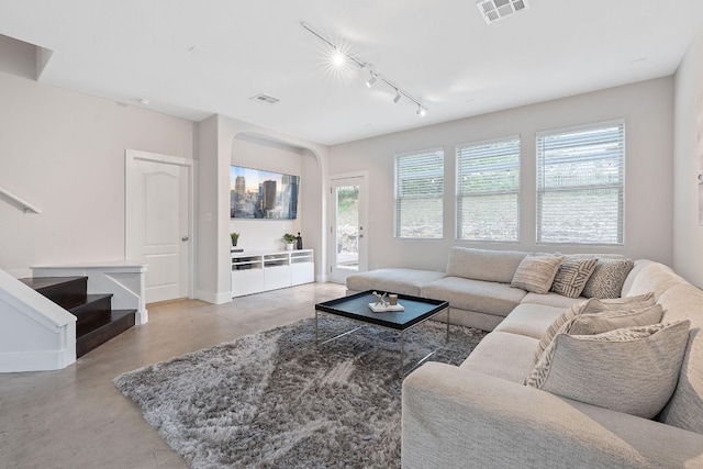 6224 Aviara Dr Unit E14, Austin, TX 78735 - living room featuring finished concrete floors, track lighting, arched walkways, baseboards, and stairs