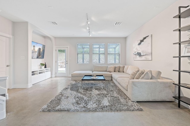 6224 Aviara Dr Unit E14, Austin, TX 78735 - living room featuring finished concrete floors, rail lighting, and baseboards