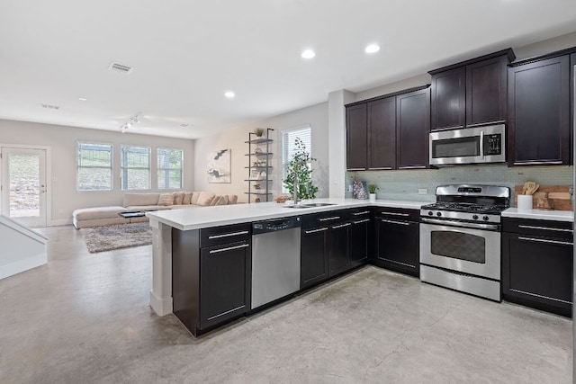 6224 Aviara Dr Unit E14, Austin, TX 78735 - kitchen featuring stainless steel appliances, concrete floors, a sink, open floor plan, and recessed lighting