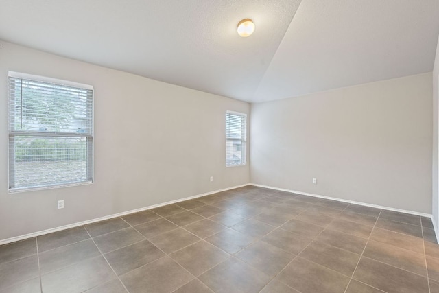 6224 Aviara Dr Unit E14, Austin, TX 78735 - tiled spare room with vaulted ceiling and baseboards