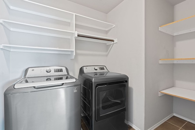 6224 Aviara Dr Unit E14, Austin, TX 78735 - washroom with separate washer and dryer and dark tile patterned flooring