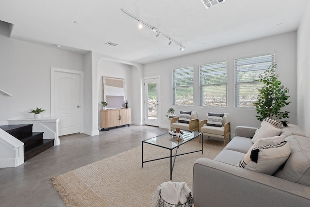 6224 Aviara Dr Unit E14, Austin, TX 78735 - living area featuring finished concrete flooring, stairway, and arched walkways