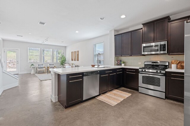 6224 Aviara Dr Unit E14, Austin, TX 78735 - kitchen with appliances with stainless steel finishes, open floor plan, healthy amount of natural light, a peninsula, and recessed lighting