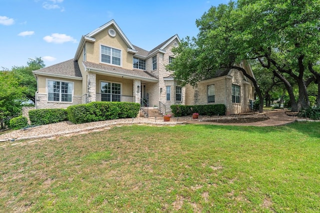 2128 Hilton Head Dr, Round Rock, TX 78664 - view of front of property featuring a front yard, stone siding, and stucco siding