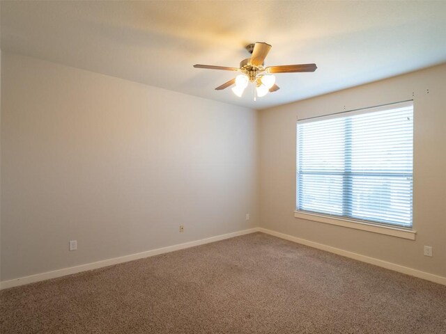 unfurnished room with baseboards, carpet floors, and ceiling fan