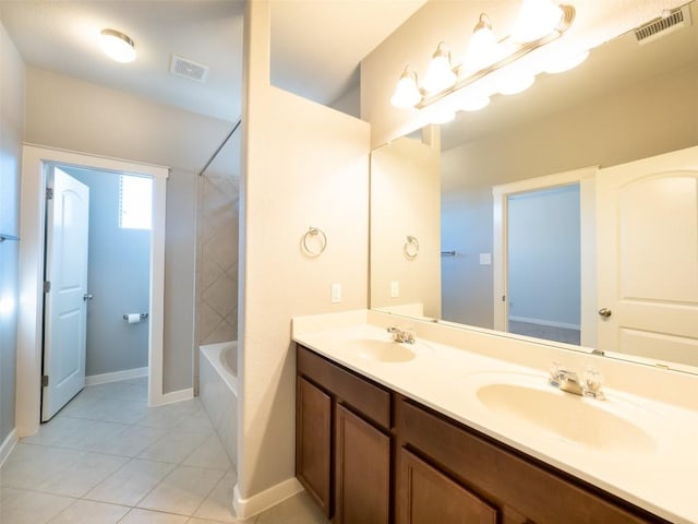 full bathroom with double vanity, visible vents, tile patterned flooring, and a sink