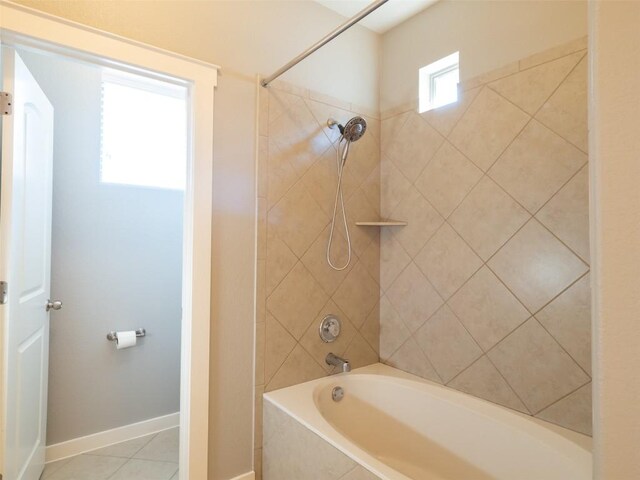 full bath featuring baseboards, washtub / shower combination, and tile patterned floors