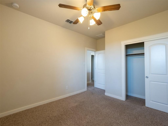 unfurnished bedroom featuring baseboards, visible vents, carpet, a ceiling fan, and a closet