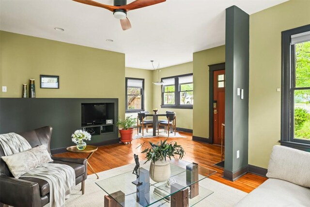 1709 Bouldin Ave, Austin, TX 78704 - living room featuring plenty of natural light, wood finished floors, a ceiling fan, and baseboards