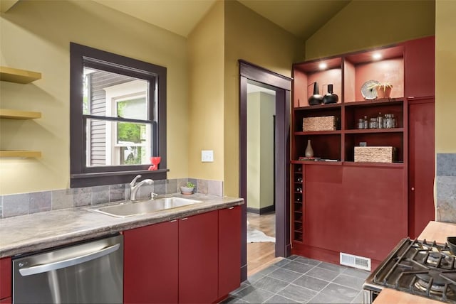 1709 Bouldin Ave, Austin, TX 78704 - kitchen with stainless steel dishwasher, open shelves, a sink, red cabinetry, and light countertops