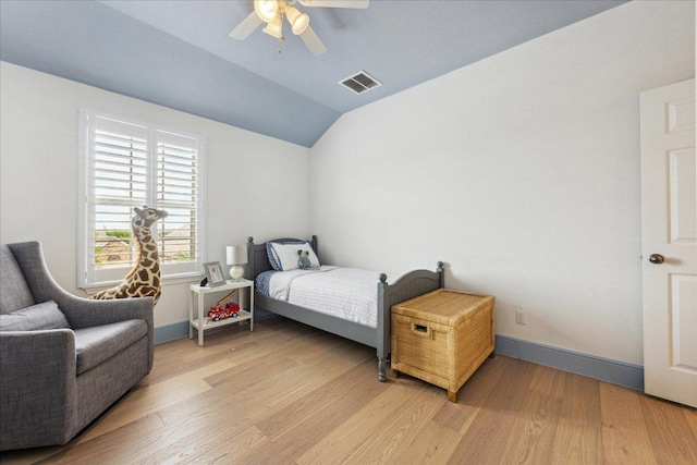 bedroom with lofted ceiling, light wood-style floors, baseboards, and ceiling fan