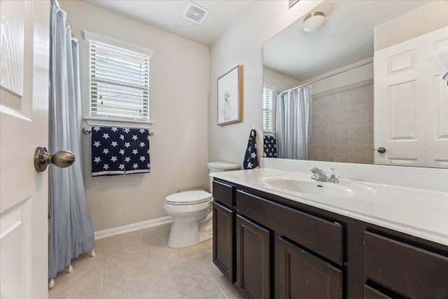 bathroom with healthy amount of natural light, tile patterned floors, baseboards, and toilet