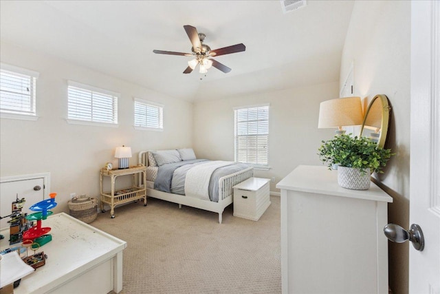 bedroom with multiple windows, light colored carpet, and ceiling fan