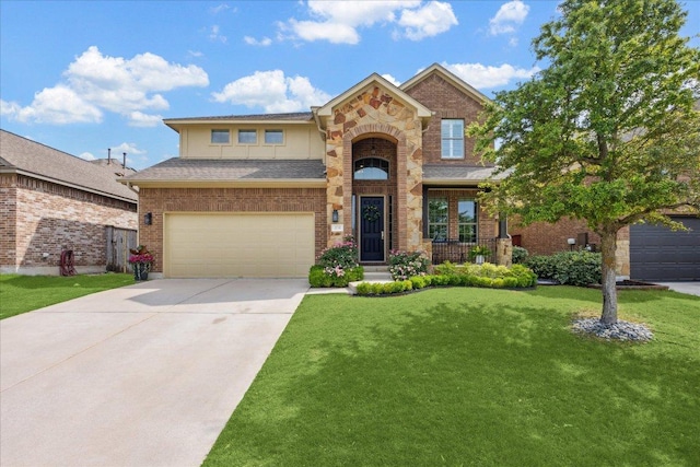 traditional home featuring concrete driveway, an attached garage, a front lawn, roof with shingles, and brick siding