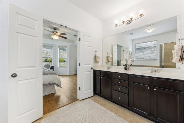 bathroom with ensuite bath, ceiling fan, double vanity, and wood finished floors