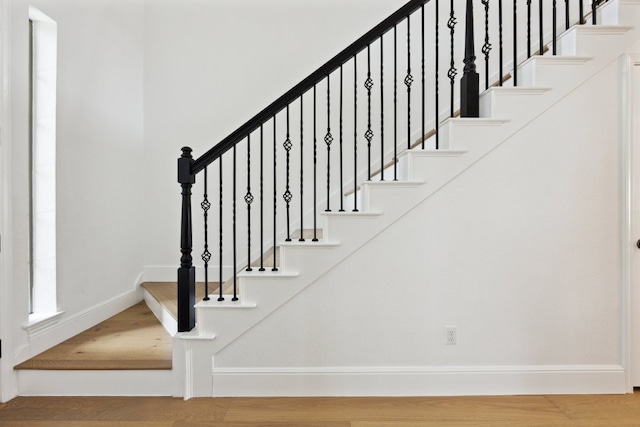 stairs featuring baseboards and wood finished floors