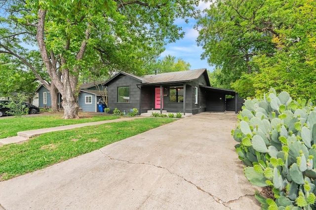 5602 Joe Sayers Ave, Austin, TX 78756 - mid-century home with concrete driveway, a front lawn, and a carport