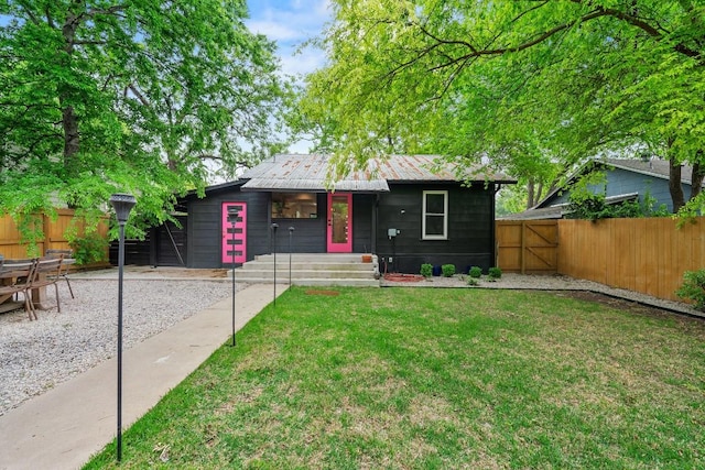 5602 Joe Sayers Ave, Austin, TX 78756 - view of front of house with a metal roof and a gate