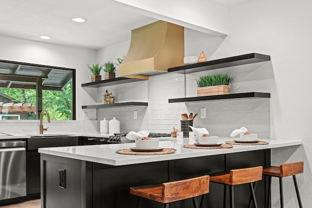 5602 Joe Sayers Ave, Austin, TX 78756 - kitchen with open shelves, dark cabinetry, stainless steel dishwasher, decorative backsplash, and a breakfast bar