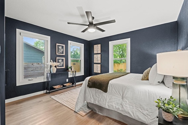 5602 Joe Sayers Ave, Austin, TX 78756 - bedroom featuring wood finished floors, a textured wall, and ceiling fan