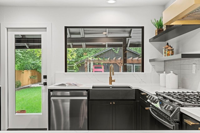 5602 Joe Sayers Ave, Austin, TX 78756 - kitchen with dark cabinets, plenty of natural light, light countertops, backsplash, and recessed lighting