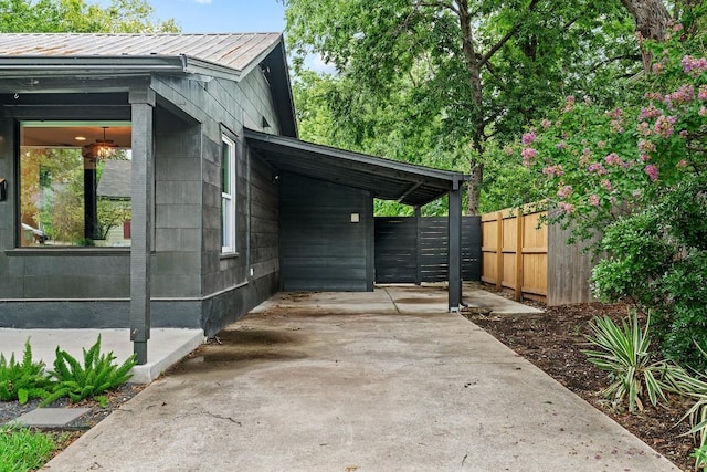 5602 Joe Sayers Ave, Austin, TX 78756 - view of property exterior with an attached carport, a metal roof, and concrete driveway