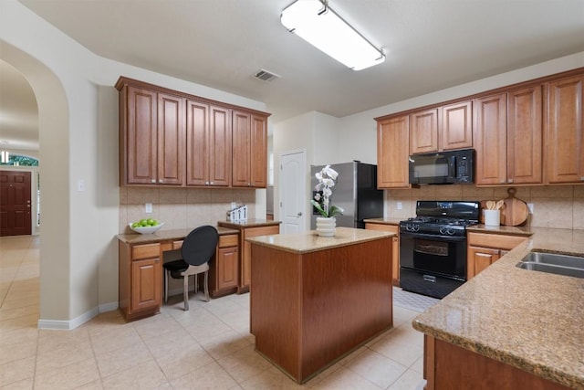 kitchen featuring black appliances, arched walkways, backsplash, visible vents, and a kitchen island