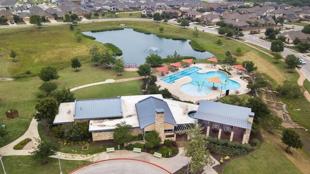 drone / aerial view featuring a residential view and a water view