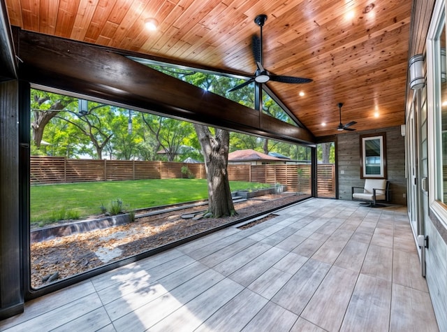unfurnished sunroom with a ceiling fan
