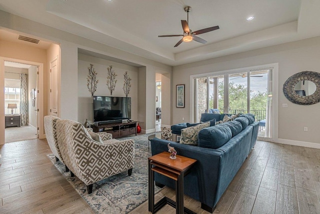513 Freeing Oak St, San Marcos, TX 78666 - living room featuring a tray ceiling, a ceiling fan, light wood-style flooring, baseboards, and recessed lighting