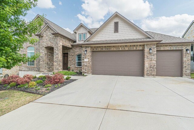 513 Freeing Oak St, San Marcos, TX 78666 - view of front of property featuring a garage, driveway, and brick siding