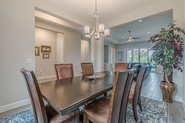 513 Freeing Oak St, San Marcos, TX 78666 - dining room with a ceiling fan, wood finished floors, baseboards, a chandelier, and a tray ceiling