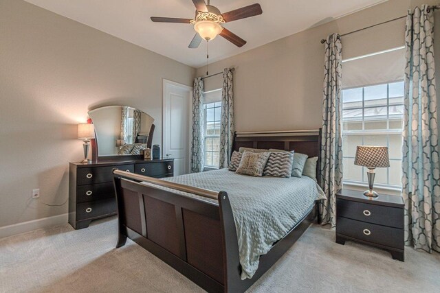 513 Freeing Oak St, San Marcos, TX 78666 - bedroom with multiple windows, light carpet, baseboards, and a ceiling fan
