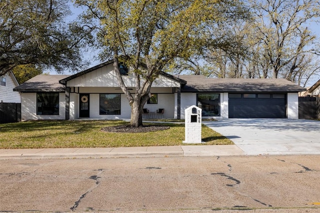 1908 Carter Creek Pkwy, Bryan, TX 77802 - view of front of property featuring concrete driveway, a front lawn, fence, and a garage