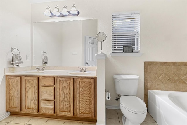bathroom featuring tile patterned floors, a garden tub, a sink, and toilet