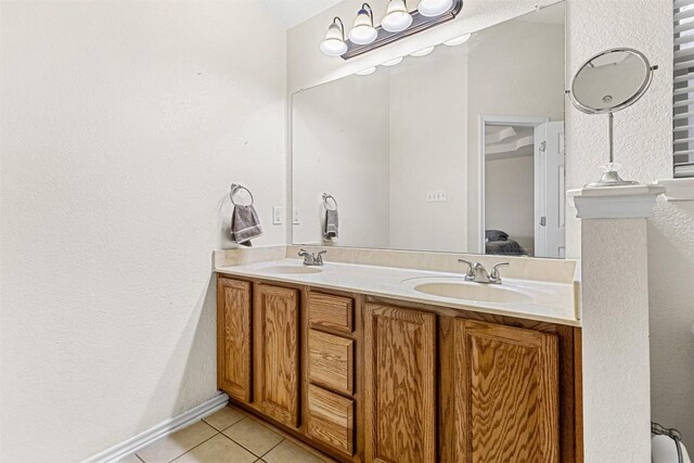 full bath with tile patterned flooring, ensuite bath, a sink, and double vanity
