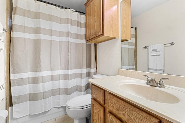 bathroom with tile patterned flooring, toilet, vanity, and shower / bath combo with shower curtain
