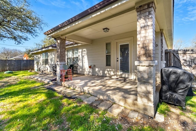 back of property featuring a yard, a patio area, and a fenced backyard