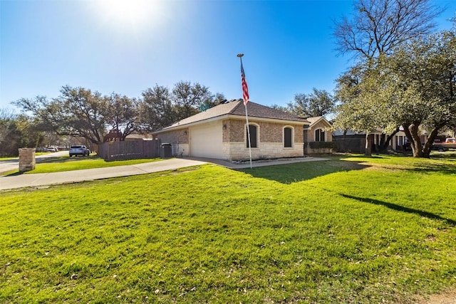 exterior space featuring a lawn, an attached garage, driveway, and fence