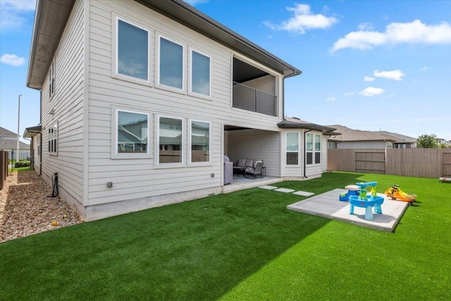 7913 Edmondson Bnd, Austin, TX 78744 - rear view of property with a balcony, a patio area, and a fenced backyard