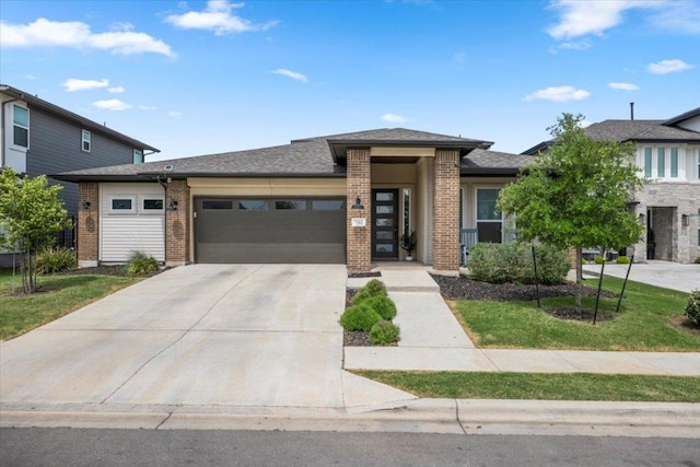 7913 Edmondson Bnd, Austin, TX 78744 - prairie-style house featuring a garage, concrete driveway, and brick siding
