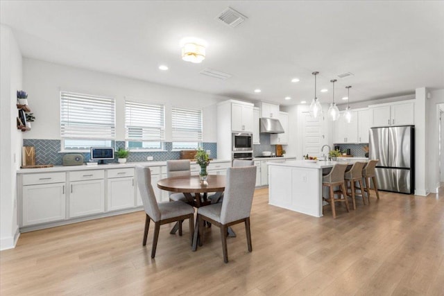 7913 Edmondson Bnd, Austin, TX 78744 - dining area featuring recessed lighting and light wood-style floors