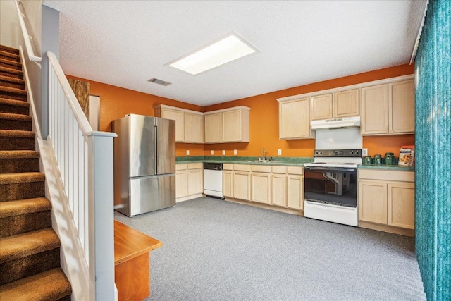 kitchen featuring a sink, visible vents, light colored carpet, white appliances, and under cabinet range hood