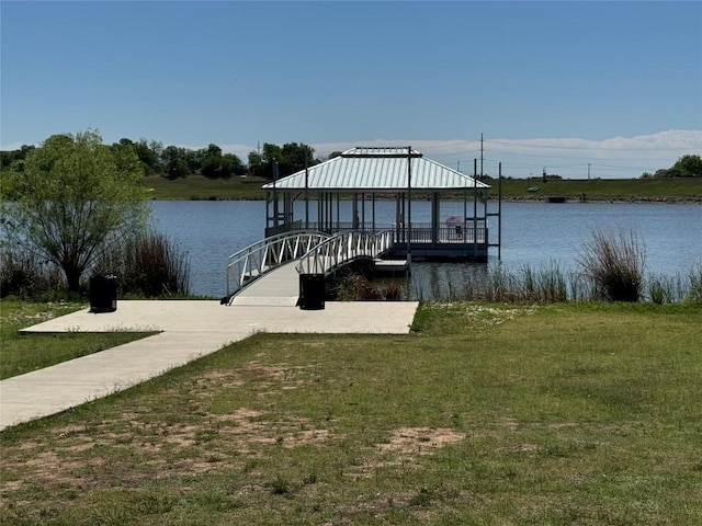 dock area featuring a gazebo, a yard, and a water view