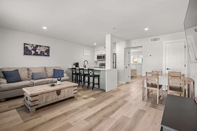 1203 Hollow Creek Dr Unit 101, Austin, TX 78704 - living room with light wood-style flooring and recessed lighting